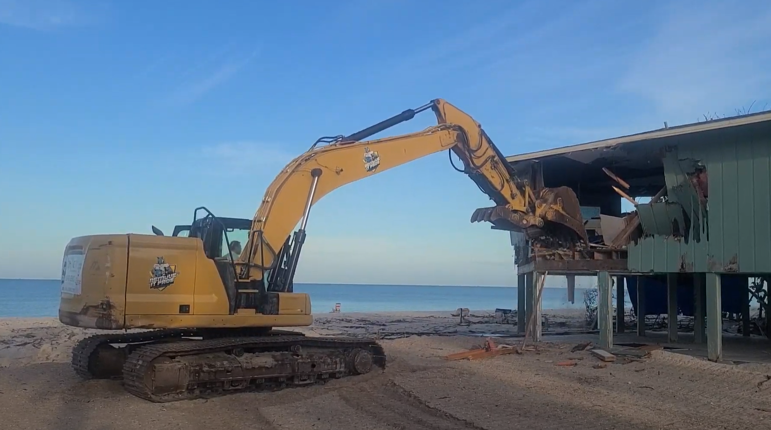 Caterpillar Excavator demolishing a house