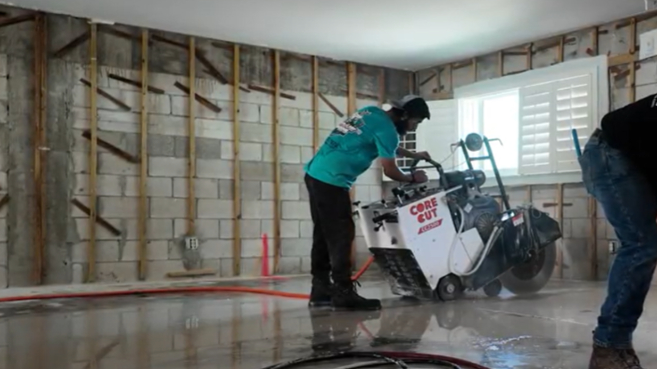 Cutting a slab of concrete with a walk behind wet saw. In Naples, Florida
