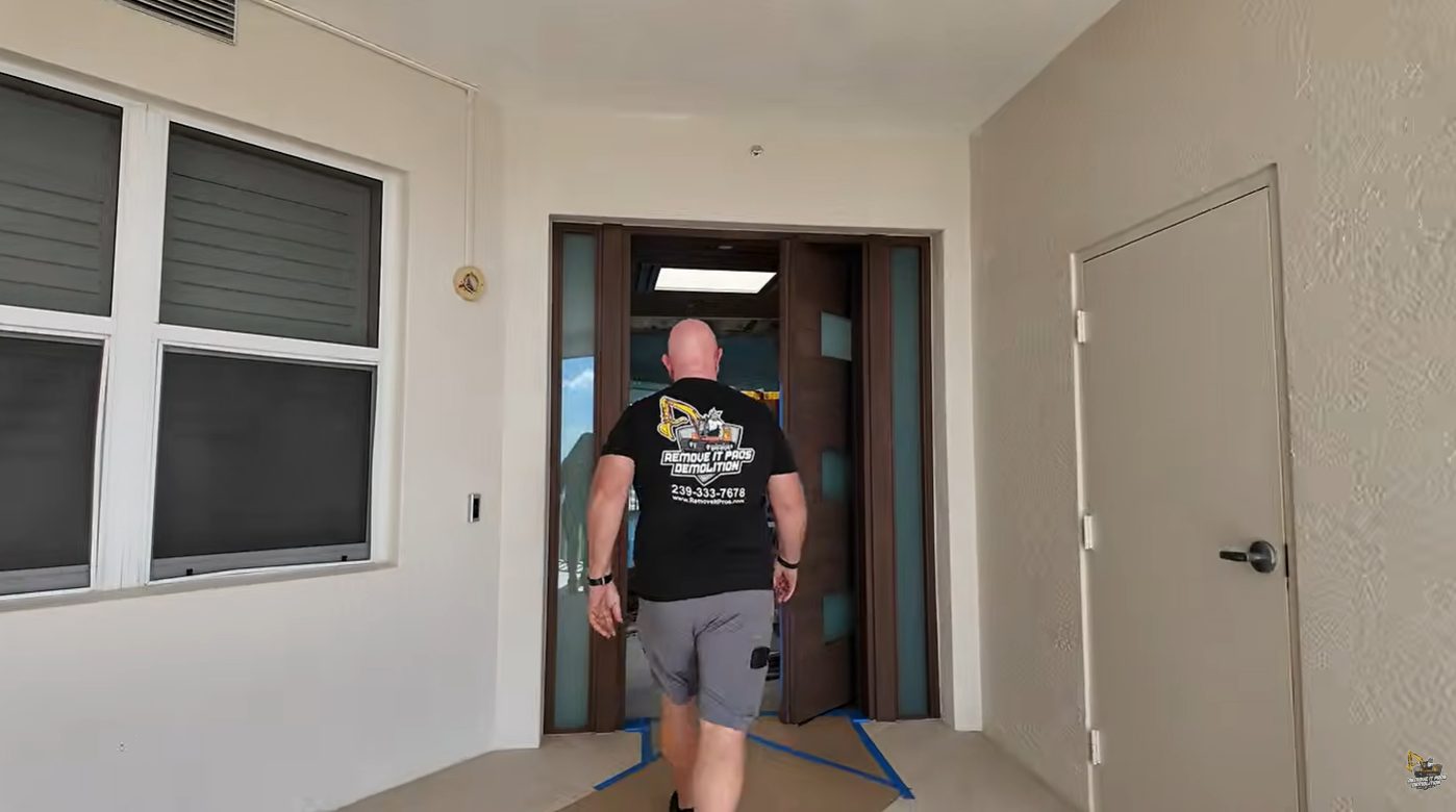 Floor protection taped down at a condo unit entry door before selective demolition
